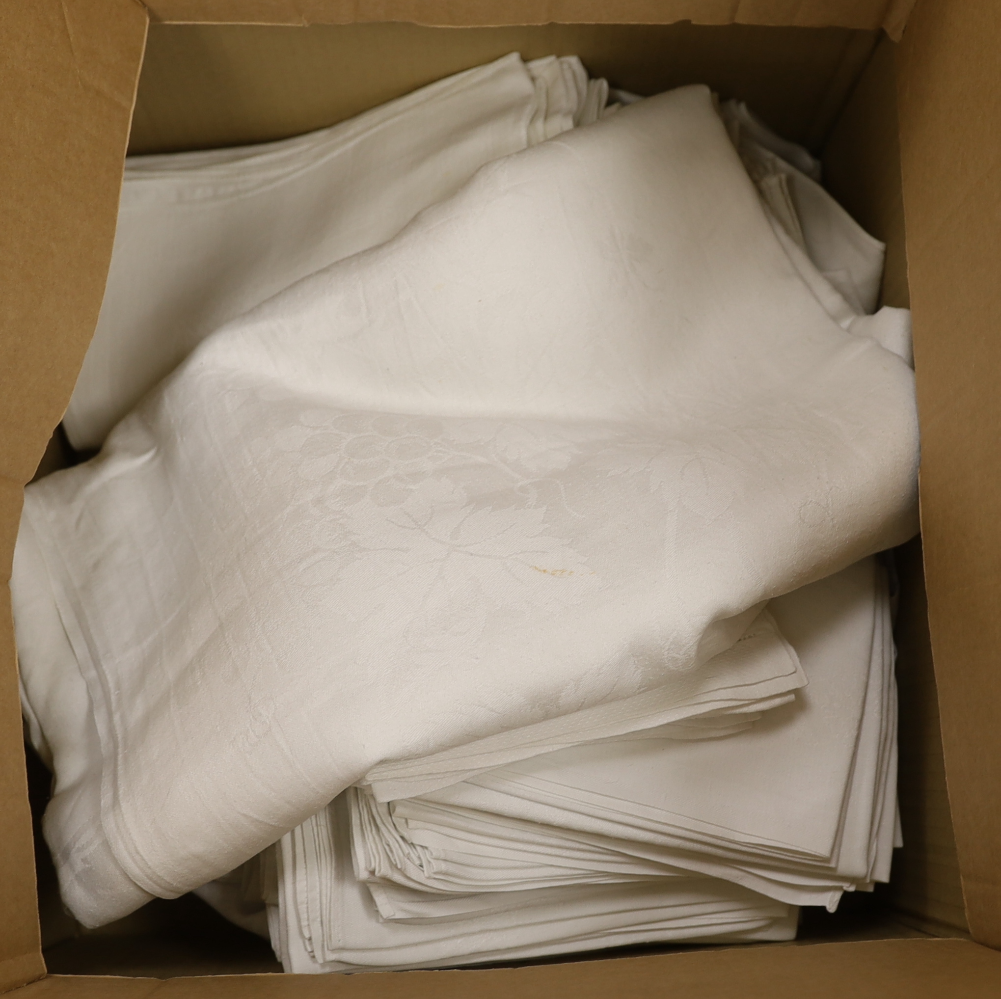 A collection of 20th century damask tablecloths and napkins including a banqueting cloth